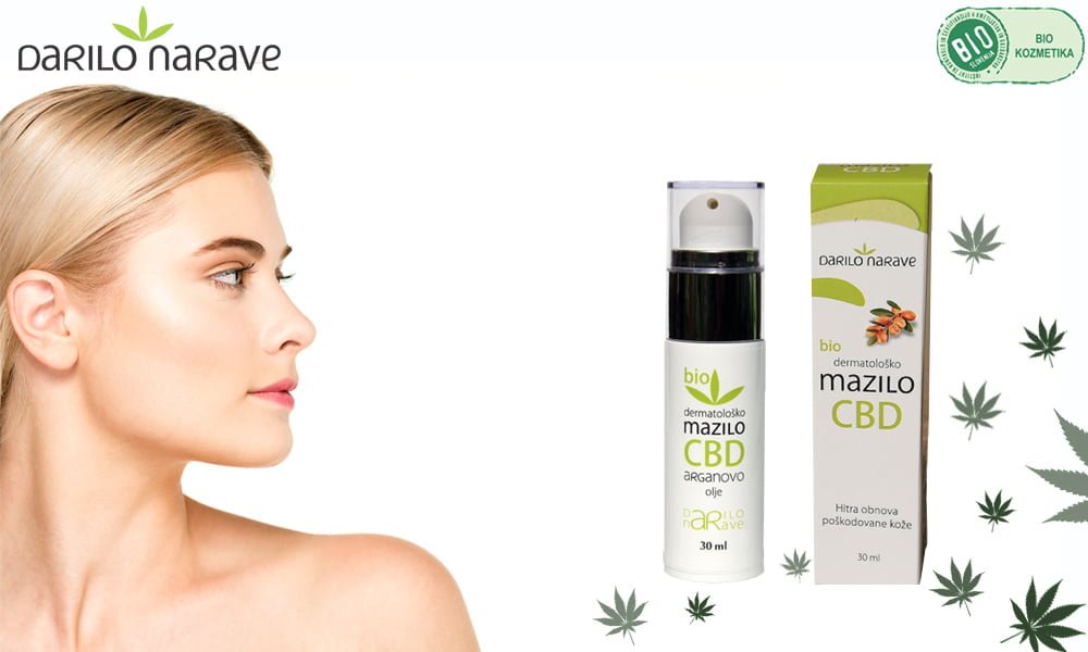 Slika prikazuje ženski obraz na levem delu slike, na desnem delu slike je viden produkt od Darila Narave Bio dermatološko mazilo s CBD in arganovim oljem
